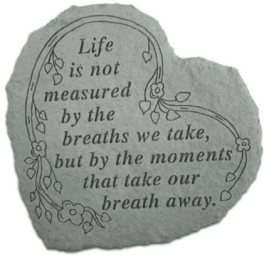 Gray stone plaque with a floral quote and vine illustration