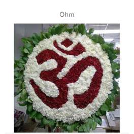Round floral wreath with a red and white symbol in the center