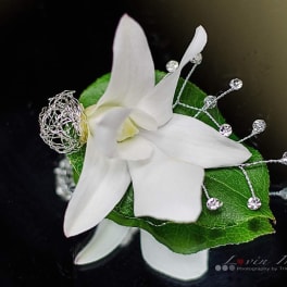 White orchid corsage with green leaf and silver bead accents