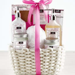Spa gift basket with cherry blossom bath products and pink ribbon