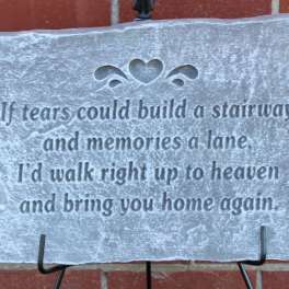 Decorative stone plaque with a memorial quote