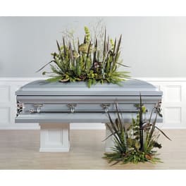Casket with two tall green floral sprays