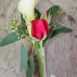 Boutonniere with a white calla lily and red rose bud