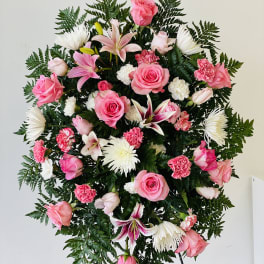Standing floral spray with pink roses, lilies, and white chrysanthemums