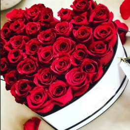 Heart-shaped box filled with red roses