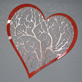 Red heart-shaped wall decor with a silver tree cutout