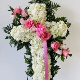 White floral standing spray with pink roses and ribbon