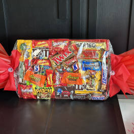 Wrapped candy gift basket with assorted chocolate and gummy bars