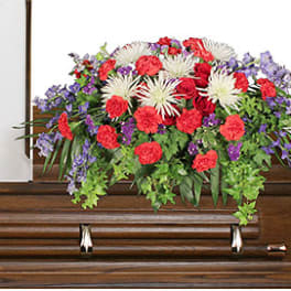 Casket spray with red, white, and purple flowers