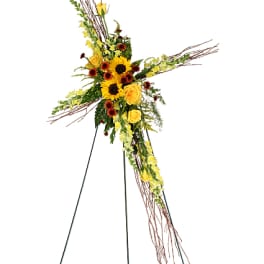 Tall floral standing cross with yellow flowers and sunflowers