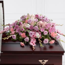 Pink and lavender floral casket spray with roses and carnations