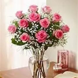 Pink roses arranged in a clear glass vase