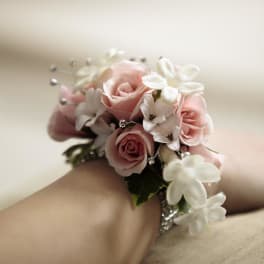 Pink rose and white flower wrist corsage on a jeweled bracelet