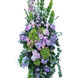 Tall floral standing spray with pink, purple, and green blooms