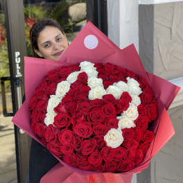 Large bouquet of red and white roses wrapped in pink paper