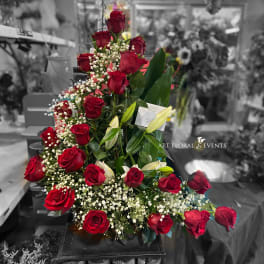 Tall arrangement of red roses with white baby's breath and lilies
