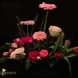 Pink and red mixed flower arrangement with tulips and roses