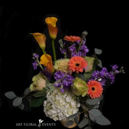 Bouquet with orange calla lilies, gerbera daisies, purple flowers, and white hydrangea
