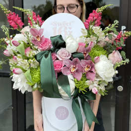 Large pink and white flower arrangement in a white hat box with a ribbon