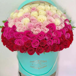 Heart-shaped box filled with pink, white, and red roses