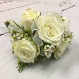 Small bouquet of white roses with ribbon accents