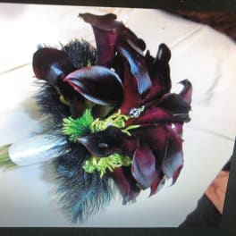 Dark burgundy calla lily bouquet with green accents