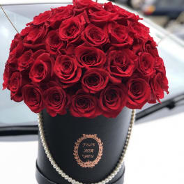 Red rose bouquet in a black hat box with pearl trim
