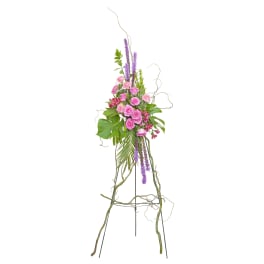 Tall floral arrangement with pink roses and purple spikes on a metal stand