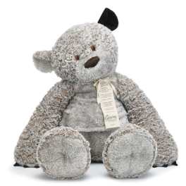 Plush teddy bear with a ribbon tag, seated on a white background
