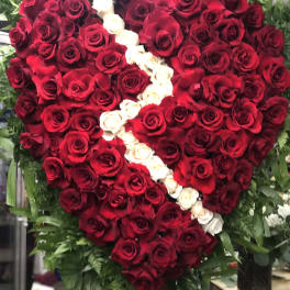 Heart-shaped rose arrangement with red and white roses