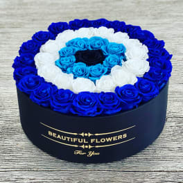 Round box of blue, white, and turquoise roses
