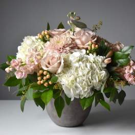 Blush roses and white hydrangeas in a gray vase