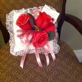 Small pillow with red roses and pink ribbons