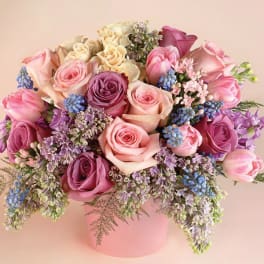 Pink and lavender rose bouquet in a pink box