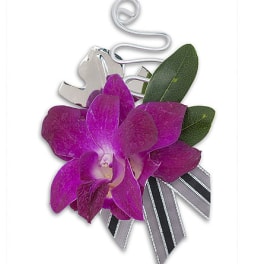 Purple orchid corsage with ribbon and silver clip
