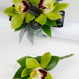 Green orchid bouquet and matching boutonniere with dark ribbon
