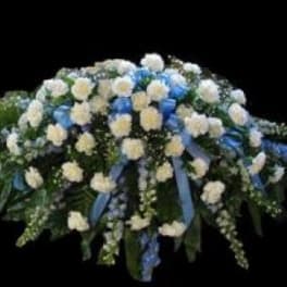 White and blue floral funeral spray with cascading ribbons