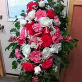 Standing floral spray with pink, red, and white blooms