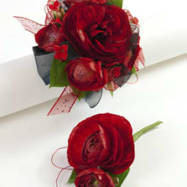 Red floral boutonniere and matching wrist corsage with ribbon accents