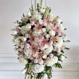 Large pink and white floral standing spray on an easel