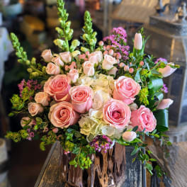 Pink roses and white hydrangeas in a copper vase