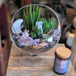 Succulent terrarium in a glass bowl with crystals and stones