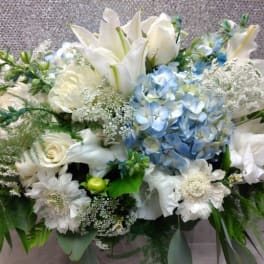 White and blue floral arrangement with lilies and hydrangeas