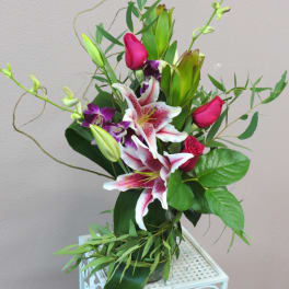 Bouquet of pink roses and white lilies with purple orchids