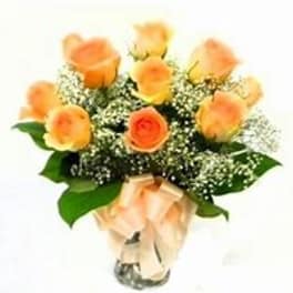 Bouquet of orange roses with baby's breath and a peach ribbon