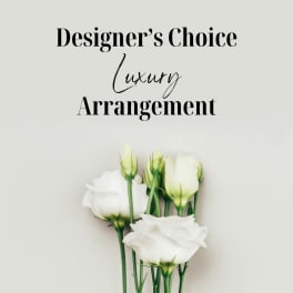White lisianthus stems with buds on a light background beneath the text “Designer’s Choice Luxury Arrangement”.