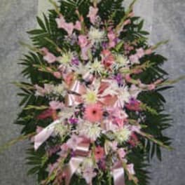 Pink and white floral standing spray with ribbon accents