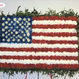 Floral arrangement shaped like the U.S. flag with red, white, and blue flowers
