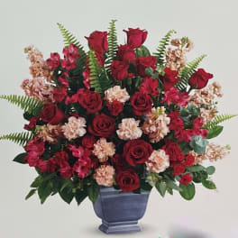 Red roses and pink carnations in a blue vase