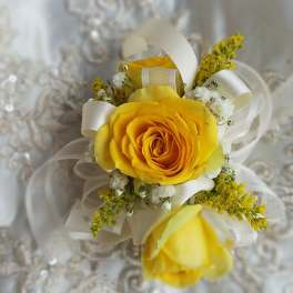 Yellow rose boutonniere with white ribbon and small white filler flowers